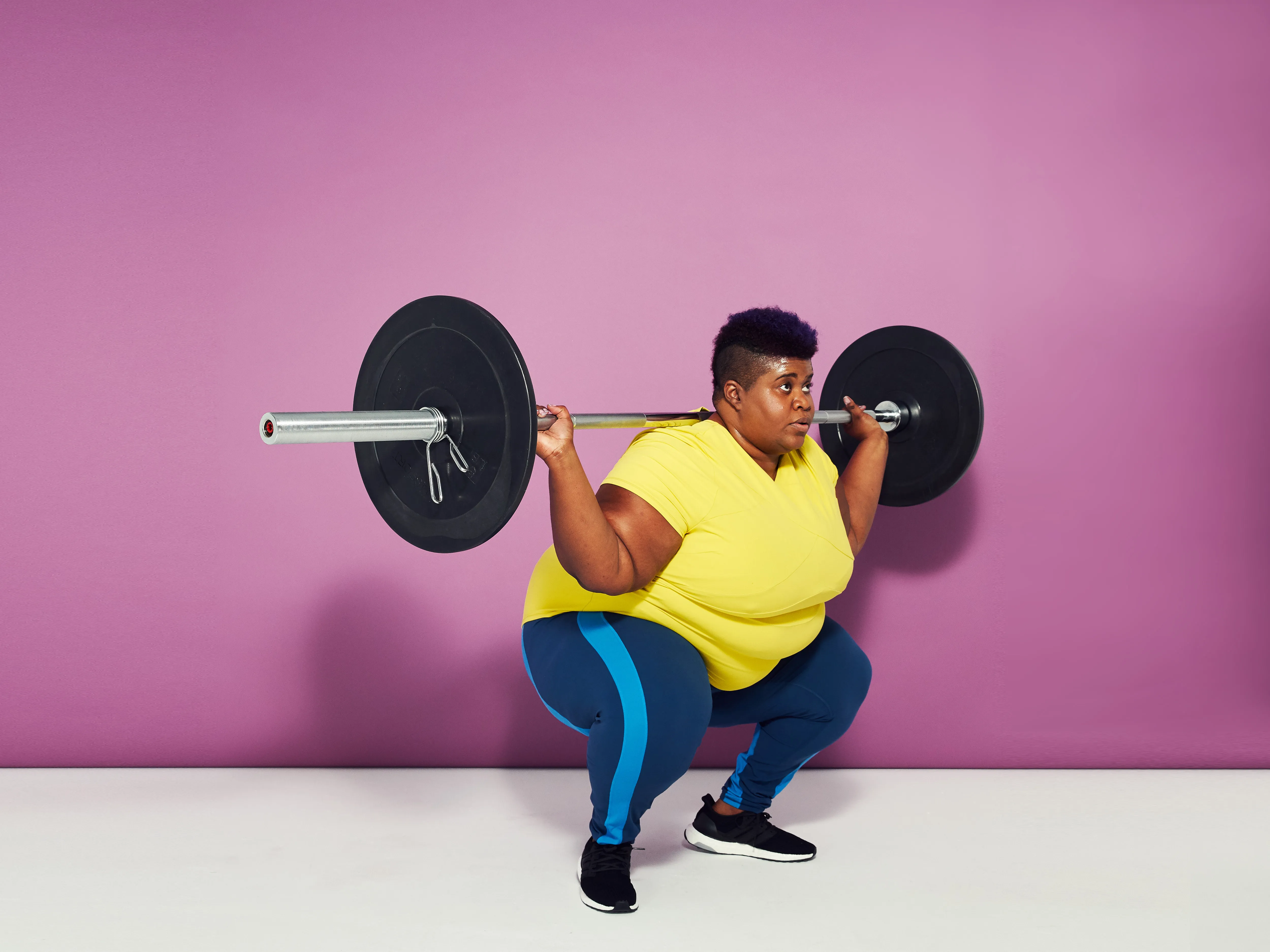 woman using a barbell for backsquat